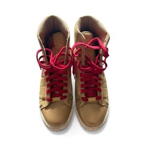 Nike yellow/gold and red shoelaces high-cut sneakers.